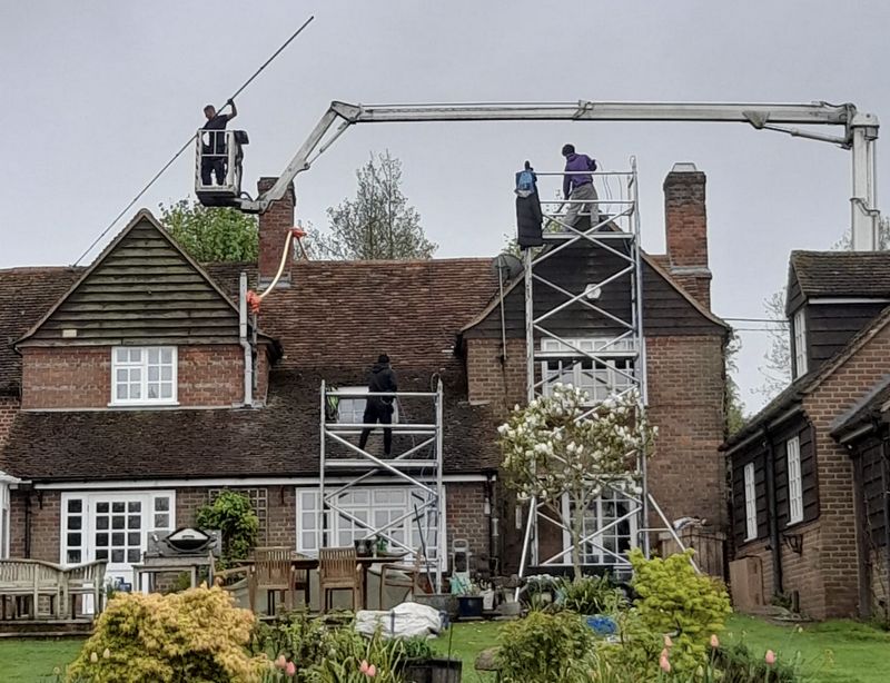 The Moss Cleaners using cherry picker and scaffolding to clean roof safely and professionally in Quedgeley, Gloucestershire